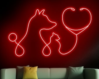 May include: Red neon sign with a dog, cat, and a stethoscope in the shape of a heart. The sign is mounted on a wall above a green couch with yellow pillows. The text "handmadetneonsign" is at the bottom of the image.
