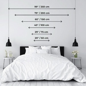 May include: A white bed with a white duvet cover and two white pillows. The bed is in a bedroom with white walls and two black pendant lights hanging from the ceiling. The bed is 79 inches wide and 99 inches long. Measurements are also provided in centimeters.