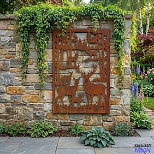 May include: A rectangular, rust-coloured metal wall art piece depicting a forest scene with deer. The artwork is mounted on a stone wall, with greenery and plants surrounding it. The deer are shown in various sizes, with a large buck prominently displayed.