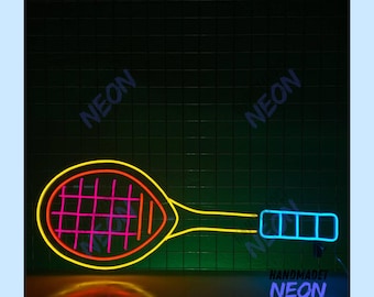 May include: A neon sign shaped like a tennis racket with a yellow outline, a red interior, and a pink net. The handle is yellow with a blue neon rectangle at the end. The sign reads "Handmade Neon".