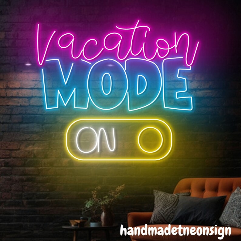 May include: Neon sign with the text "Vacation Mode On" in pink, blue, and yellow. The sign is on a brick wall background.