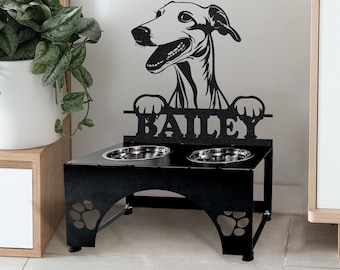 May include: Black metal dog bowl stand with a silhouette of a Greyhound dog and the name "Bailey" cut out. The stand has two bowls and paw print cutouts on the legs.