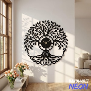 May include: A circular black wall clock featuring an intricate laser-cut design of a tree with sprawling branches and roots. The clock face is integrated into the center of the tree trunk, displaying black numerals and thin gold-colored clock hands.