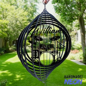 May include: Black metal wind spinner featuring a drum set silhouette with the name "William" in a cursive font. The wind spinner has a spiral design and the text "HANDMADET NEON" is at the bottom.