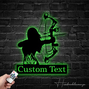 May include: Green neon sign with a silhouette of a person holding a bow and arrow. The sign has a custom text area that says "Custom Text".