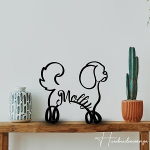 May include: Black metal silhouette of a dog with the name "Molly" written in a cursive font. The silhouette is standing on a wooden shelf with a potted cactus and a decorative vase.