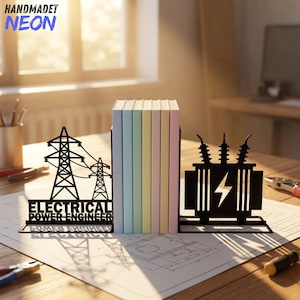May include: A pair of black metal bookends holding a row of colorful books. One bookend features a silhouette of electrical transmission towers with the text ELECTRICAL POWER ENGINEER, while the other shows a transformer icon with a lightning bolt symbol.