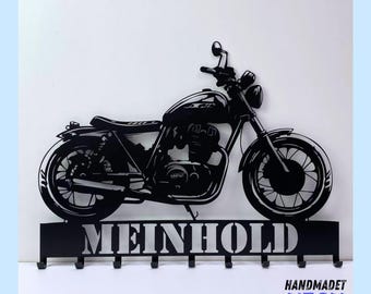 May include: Black metal motorcycle key holder with the word "MEINHOLD" in white lettering. The motorcycle silhouette has a detailed design and includes hooks for hanging keys.