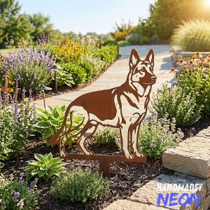 May include: A rust-coloured metal garden stake featuring a cutout silhouette of a German Shepherd dog standing in profile. The dog figure is mounted on a thin metal post designed to be inserted into the ground for outdoor display.