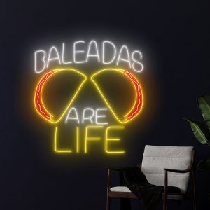 May include: Neon sign with the words "Baleadas are life" in yellow and white. The sign features two yellow and orange baleadas, a Honduran dish, in the shape of a heart.