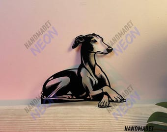 May include: Black metal silhouette of a Greyhound dog lying down. The silhouette is a wall decor piece with a handmade neon sign logo.