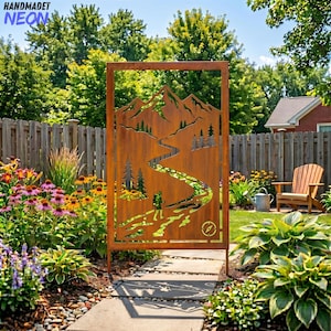 May include: A rectangular, rusty-brown metal garden screen featuring a mountain and river scene. The design includes a hiker, trees, and a compass. The screen is set in a garden with flowers and a wooden fence.