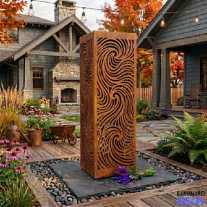 May include: A tall, rectangular, outdoor metal sculpture with a swirling, cut-out design. The sculpture is a rusty brown color and stands on a stone base. The background includes a house, garden, and string lights.