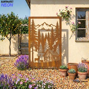 May include: A rectangular, rust-colored metal art piece featuring a mountain and forest scene with a cabin, deer, and bear silhouette. The top left corner has the text "HANDMADET NEON" in blue. The art is displayed outdoors with plants and a stone ground.