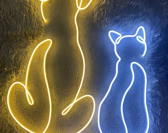 May include: A neon sign featuring a dog and a cat, each depicted in a continuous line. The dog is illuminated in yellow, while the cat glows in blue. The sign is mounted on a textured, dark gray surface.