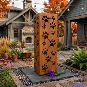 May include: A tall, rectangular, rusted metal outdoor sculpture featuring paw print cutouts. The paw prints are connected by lines, creating a unique design. The sculpture is placed in a garden setting with a house in the background.