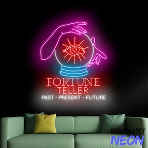 May include: Neon sign with a pink and blue fortune teller's crystal ball with an eye inside. The sign reads "Fortune Teller" and "Past - Present - Future".