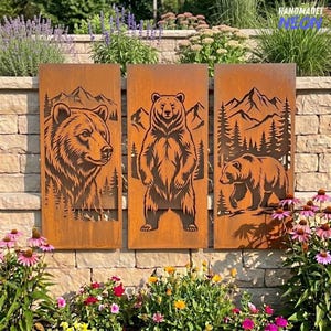 May include: Three rectangular metal panels with a rusted finish, each featuring laser-cut silhouettes of bears in a mountain forest landscape. The left panel shows a bear head, the center shows a standing bear, and the right shows a walking bear.
