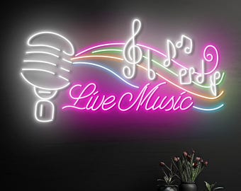 May include: A neon sign with a white microphone, musical notes, and the words "Live Music" in pink. The sign has a black background and is decorated with a few potted plants.