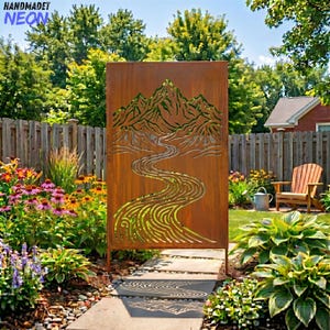 May include: A large, rectangular, rusty-brown metal garden screen with a cut-out design of mountains and a winding river. The screen is supported by two metal posts and is placed in a garden setting with flowers and a wooden fence. The text "HANDMADET NEON" is in the top left corner.