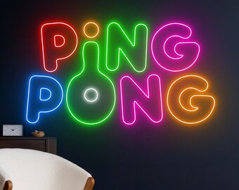 May include: A neon sign with the word "PING PONG" in rainbow colors. The letters are outlined in neon and the "I" in "PING" is a circle with a smaller circle inside.
