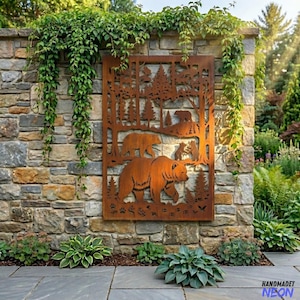 May include: A rusty brown metal wall art piece featuring a bear family in a forest scene. The artwork is mounted on a stone wall, with greenery and plants surrounding it. The bear family includes a large bear, a smaller bear, and bear cubs.