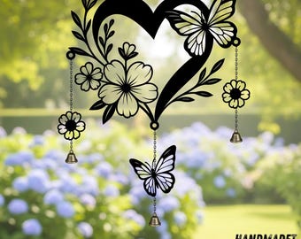 May include: Black metal heart-shaped wall decoration featuring floral and butterfly cutouts. The design includes flowers, butterflies, and small bells suspended on chains. The text "HANDMADET NEON" is at the bottom.