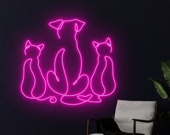 May include: Pink neon sign depicting a dog and two cats sitting together. The dog is in the center and the cats are on either side of the dog. The neon sign is on a dark wall.