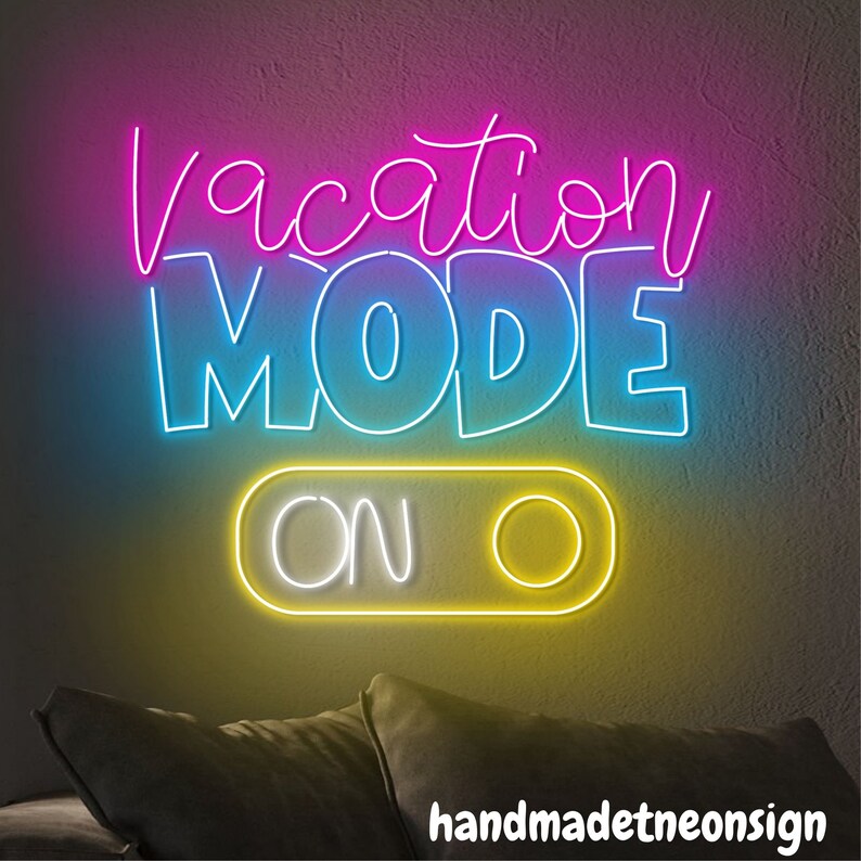 May include: Neon sign with the text "Vacation Mode On" in pink, blue, and yellow. The sign is on a wall with a couch in the foreground.