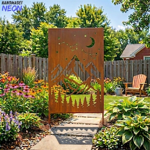 May include: A rusty brown metal garden screen featuring a mountain and forest design with cut-out stars and a crescent moon. The screen is placed in a garden with a stone pathway, flowers, and a wooden fence in the background. The word "HANDMADET NEON" is in the top left corner.