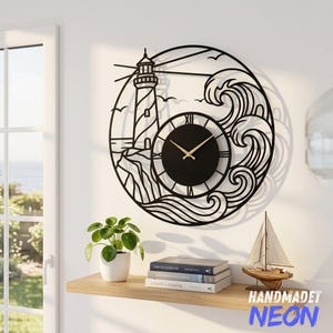 May include: A circular black metal wall clock featuring a cutout design of a lighthouse on a rocky cliff with crashing ocean waves. The clock face is solid black with gold-colored hands and Roman numerals, integrated into the metal frame.