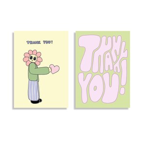 Könnte beinhalten: Zwei Dankeskarten. Eine Karte zeigt eine Cartoon-Blumenfigur, die ein rosa Herz hält, mit dem Text "THANK YOU!". Die andere Karte hat die Worte "THANK YOU!" in großen Buchstaben.