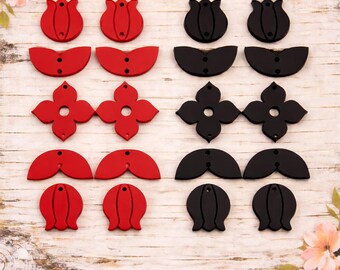 May include: A collection of red and black wooden floral-shaped cutouts. The cutouts include tulip, petal, and four-petal flower designs. Each cutout has a small hole for stringing or attaching. The items are arranged on a light wood grain surface.