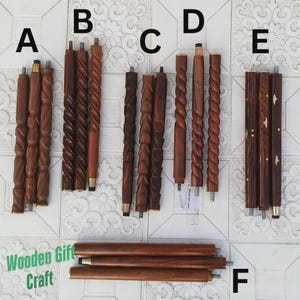 May include: A collection of intricately carved wooden walking stick shafts in various designs. The shafts are primarily brown, with some featuring brass accents. The image includes the text "Wooden Gift Craft".