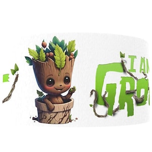 May include: A white ceramic mug featuring a cartoon illustration of a Groot-like character in a wooden pot, with green leaves and the text "I AM GROOT" in green. The design includes brown vines and a smiling face.