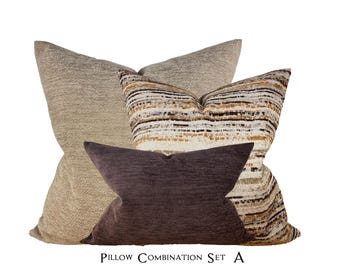 May include: A set of three decorative throw pillows. The largest pillow is a light beige with a textured fabric. The middle pillow is a striped fabric with brown, beige, and white stripes. The smallest pillow is a dark brown with a velvet-like texture. The pillows are arranged in a pyramid shape. The text "Pillow Combination Set A" is printed below the pillows.