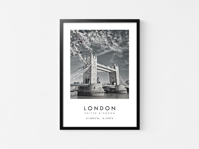 May include: Black and white framed print of the Tower Bridge in London, United Kingdom. The image includes the text "LONDON UNITED KINGDOM" and coordinates. The bridge is over the water with a cloudy sky.