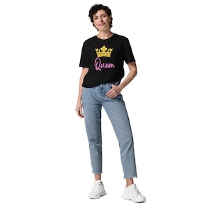 May include: A black t-shirt with a gold crown and the word "Queen" in pink lettering.