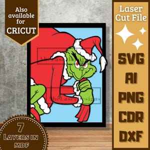 May include: A framed illustration of the Grinch in a Santa hat and red suit, carrying a sack. The image is a laser cut file, also available for Cricut, with SVG, AI, PNG, CDR, and DXF file formats. The image has 7 layers in MDF.