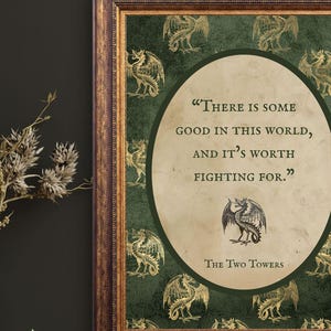 May include: Framed art print featuring a quote from "The Two Towers" on a green background with gold dragon illustrations. The quote reads, "There is some good in this world, and it's worth fighting for." The frame is a dark brown color.