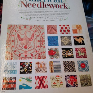May include: Book cover for "American Needlework" with a collection of 16 small images of different needlework patterns. The book cover is white with red and blue text. The book is by the editors of Woman's Day and published by Simon and Schuster.