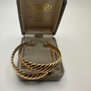 May include: Gold hoop earrings with a twisted design, in a velvet box that says "Concepts for Sensitive Ears".