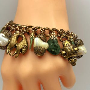 Unsigned Miriam Haskell Asian Charm Bracelet: 1950s Gold Tone, 12k Gold Filled Clasp