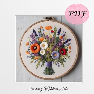 May include: A colourful floral embroidery hoop art piece featuring a bouquet of flowers. The bouquet includes orange poppies, white daisies, purple lavender, and red and purple flowers. The embroidery is set in a wooden hoop. The text "PDF" is in a pink circle.