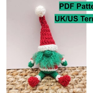 May include: Crocheted gnome with a red and white hat, green beard, and red and white striped pants.  PDF Pattern UK/US Terms.