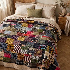 May include: A patchwork quilt featuring a variety of square fabric pieces in diverse colors and patterns, including floral, geometric, and abstract designs. The quilt is constructed with visible running stitch details throughout the surface.