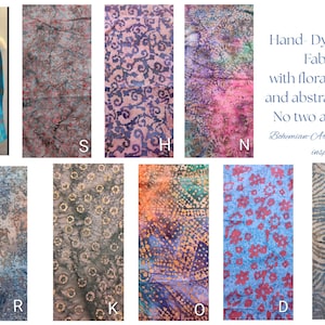 May include: Hand-dyed batik fabric with floral, dotted, and abstract motifs in various colors. The image displays several fabric samples, including a teal scarf with yellow and green floral patterns. The text reads "No two are alike!"
