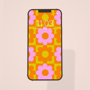 Può includere: Uno smartphone con uno sfondo a motivi floreali di colore arancione e rosa brillante. L'ora è 11:03 e la data è lunedì 14 dicembre.