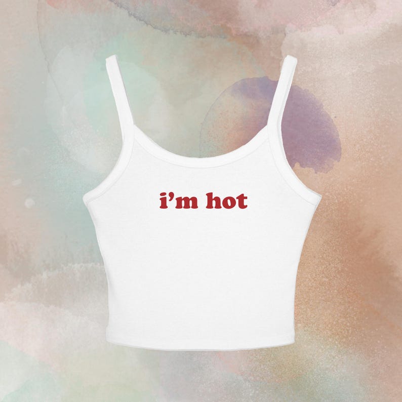 May include: White tank top with thin straps and the text "i'm hot" in red. The top is a casual style, suitable for warm weather. The background has a watercolor effect with shades of pink, green, and purple.