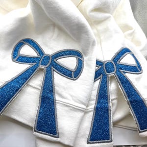 Side Bows for sweatshirt. (2) iron ons, glitter bow, iron on side bow, sweatshirt bow, cute bow for sweatshirt. They are Larger than most!